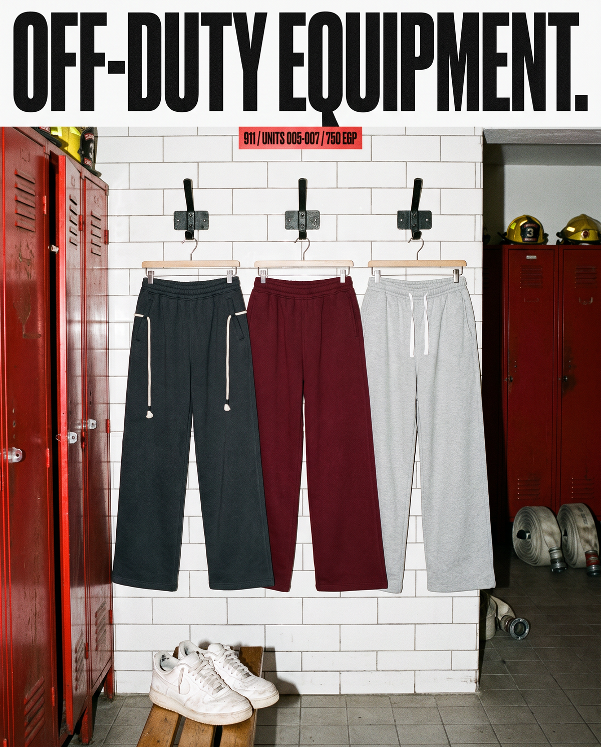 Three pairs of 911 wide-leg fleece pants hanging in a fire station locker room